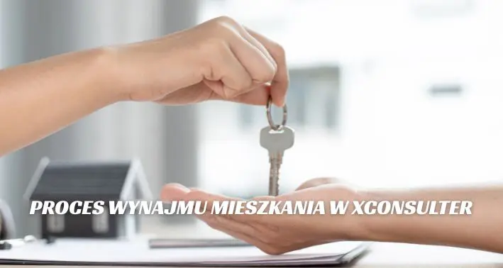 Ręka przekazująca klucze nowemu najemcy podczas podpisania umowy wynajmu mieszkania